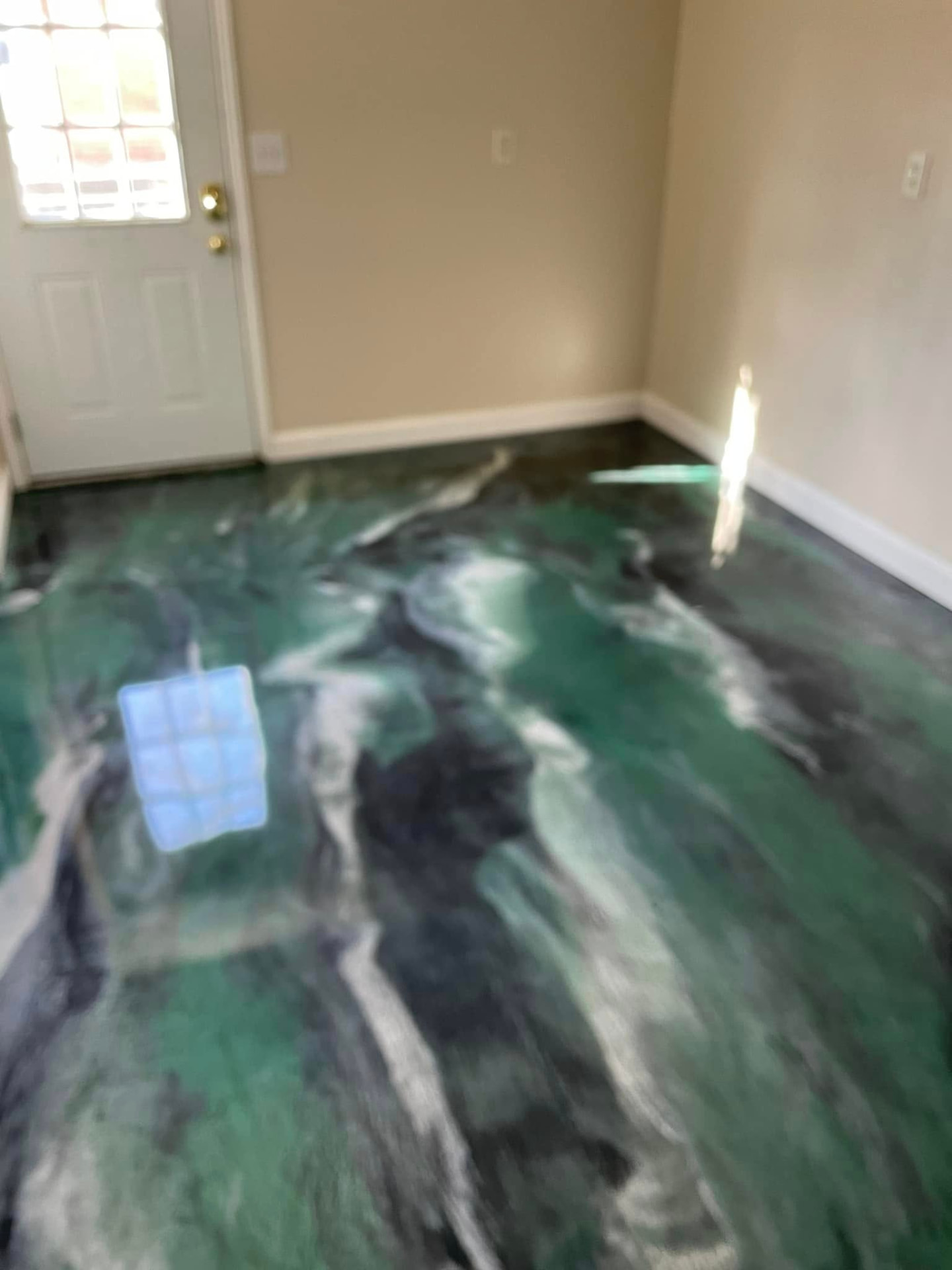 Technician diamond grinding a concrete floor with a dust extractor